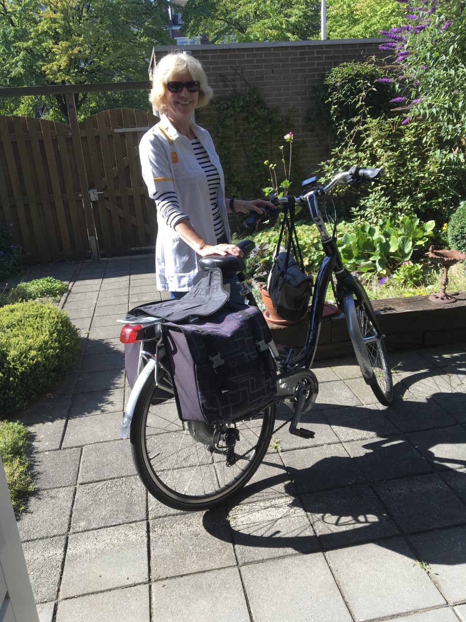 Henny vertrouwenspersoon TVN Zorgt Nijmegen op de fiets in de tuin Henny vertrouwenspersoon TVN Zorgt Nijmegen op de fiets in de tuin